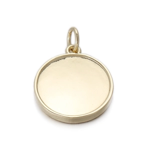 Detailed macro view of a circular pale gold brass pendant for DIY jewelry making