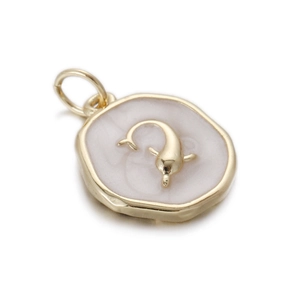 Detail of golden dolphin relief on white mother of pearl vintage pendant charm