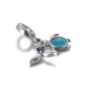 Detail of silver turtle and whale tail charm with blue enamel and sparkling zircon