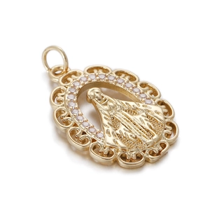 Macro detail of oval Virgin Mary pendant with retro lace edges and white zircon inlays
