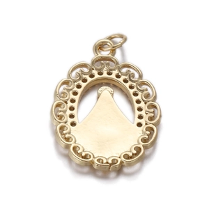 Macro detail of a vintage gold filigree oval pendant with elegant hollow border design