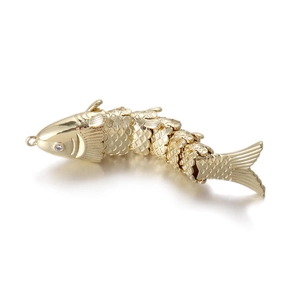 Detailed macro view of a 14k gold plated articulated koi fish pendant with white zircon eye