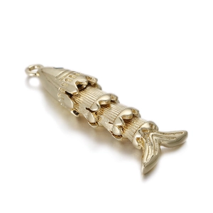 Detailed macro view of a 14k gold plated koi fish pendant with articulated segment design