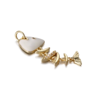 Detailed view of fish bone pendant with white enamel and sparkling inlaid crystals