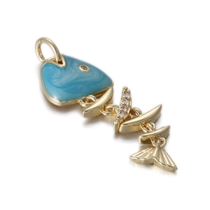 Macro shot of gold-plated fishbone pendant with blue enamel and sparkling cubic zirconia