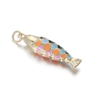 Macro shot of colorful enamel koi fish pendant with gold plating for DIY jewelry making