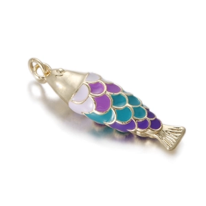 Detailed close-up of a 14k gold fish charm with purple and blue enamel fish scales