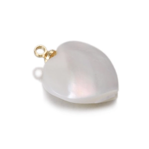 Detail of heart-shaped white shell pendant with iridescent luster and golden bail
