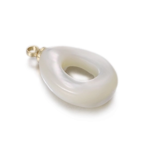 Macro shot of oval white mother of pearl pendant with golden loop for DIY jewelry