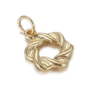 Detailed view of a 14k gold twisted circular pendant with hollow design and metal texture