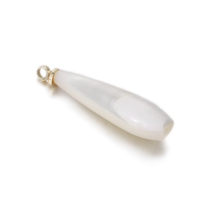 Macro shot of white teardrop shell pendant with polished golden metal loop fastener