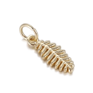 Detailed macro view of a 14k gold-plated leaf-shaped jewelry pendant on a white background