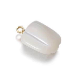 Macro detail of white vegetable shaped pendant with golden ring for DIY jewelry making