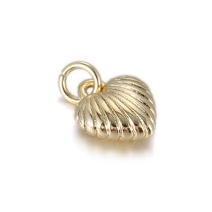 Close-up of heart-shaped gold charm with scalloped texture and round jump ring for DIY