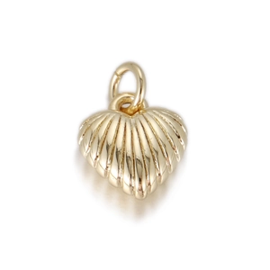 Detailed view of golden heart pendant with radial ribbed texture and dual ring top