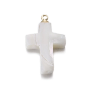 Detailed view of a white mother of pearl cross pendant with a golden metal loop bail