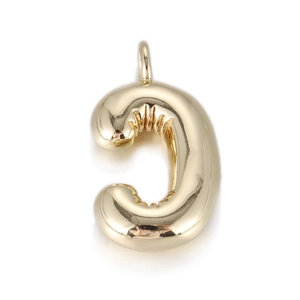 Detail of golden balloon-style letter C pendant with textured surface and metallic luster