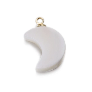 Macro detail of crescent moon white shell pendant with a golden metal loop connector