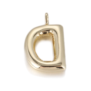 Close-up of golden balloon-style letter D pendant with polished metallic surface