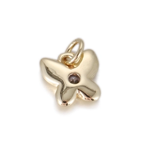 Detailed close-up of a 14k gold butterfly pendant with a central zircon stone and jump ring