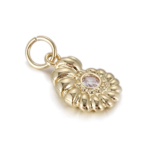 Macro shot of 14k gold nautilus shell pendant with central zircon for DIY jewelry