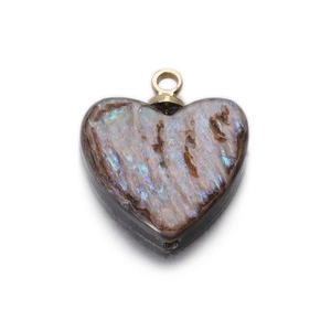 Macro shot of heart-shaped shell pendant with iridescent luster and gold metal bail