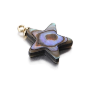 Macro detail of star-shaped mother of pearl shell pendant with golden ring connector