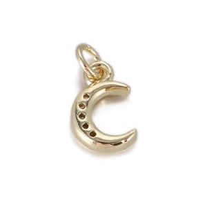 Detailed macro view of a 14k gold crescent moon charm with sparkling zircon inlay