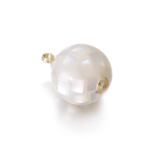 Detailed view of spherical mother of pearl pendant with gold plating for DIY jewelry