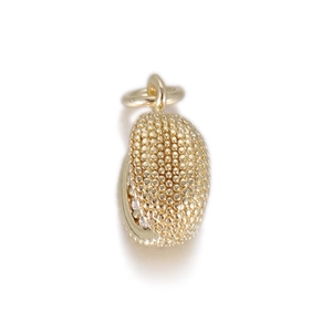 Close-up of golden bean pendant with beaded texture and circular bail for DIY jewelry