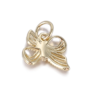 Detailed close-up of a 14k gold butterfly charm with intricate hollow texture for DIY jewelry