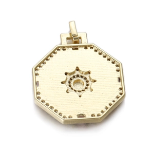 Detailed macro view of an octagonal gold-plated sunburst pendant with empty inlay slots