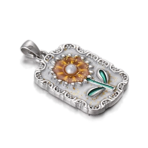 Detail of sunflower tarot pendant with white pearl center and green enamel leaves