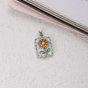 Detail of silver tarot pendant with oil-painted sunflower and white pearl inlay