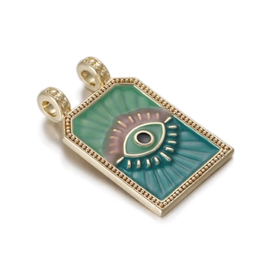 Detailed close-up of rectangular tarot pendant with evil eye motif and gold metal border