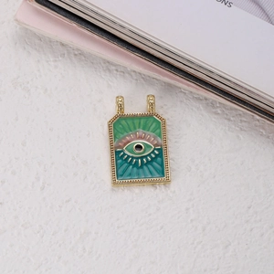 Macro view of evil eye tarot pendant with colorful enamel and gold metal frame