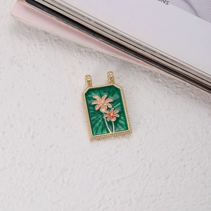 Close-up of bohemian tarot style rectangle flower pendant with gold textured frame