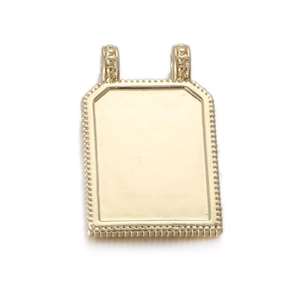 Detail of a rectangular golden tarot pendant with beaded edges and dual hanging loops