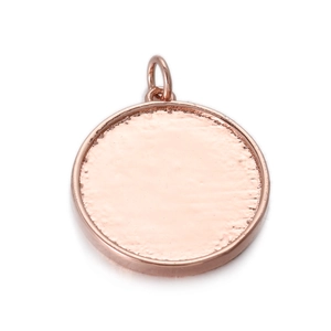 Close-up of rose gold round pendant base with bail and grooved texture for DIY jewelry