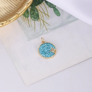 Runder goldener Anhänger mit himmelblauen Kristallen und goldenem Stern für DIY