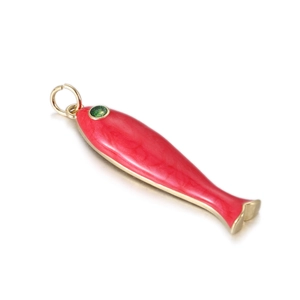 Detail of a red enamel fish charm with a green zircon eye and golden metal finish
