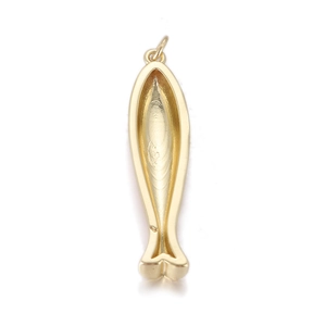 Macro shot of fish-shaped gold-plated metal pendant with detailed hollow structure