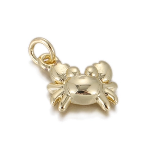Macro detail of a 18K gold-plated crab pendant for DIY jewelry and charm bracelets