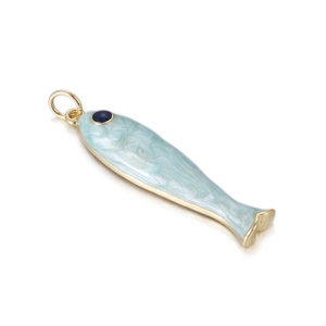 Detailed macro view of light blue enamel fish pendant with gold plating and marble texture