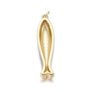 Close-up of golden fish-shaped metal pendant with fine brushed texture for jewelry DIY