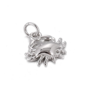 Detailed view of a silver crab pendant with jump ring for DIY jewelry making