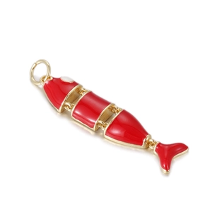 Detailed macro of a flexible red enamel fish pendant with gold-plated articulated joints