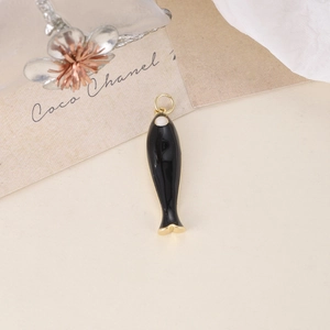Minimalist black enamel fish pendant with gold metal edges and hanging loop accessory