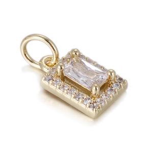 Macro shot of rectangular halo pendant with gold base and clear zircon stone