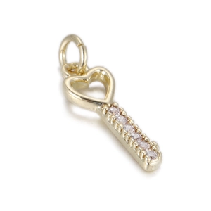 Detail of a golden heart key pendant with sparkling pavé-set zircon stones